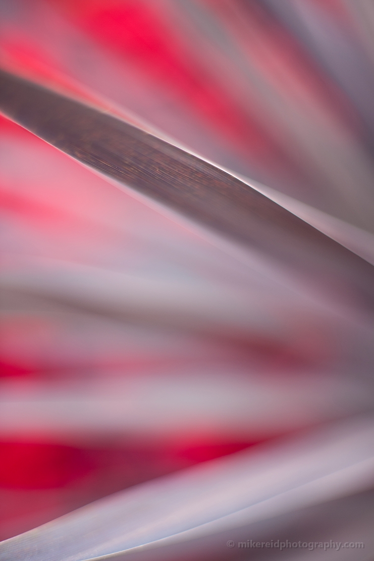 Abstract close-up of gray blades with soft red and pink motion blur